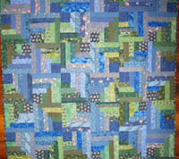 Half-log cabin quilt pattern in blues and greens